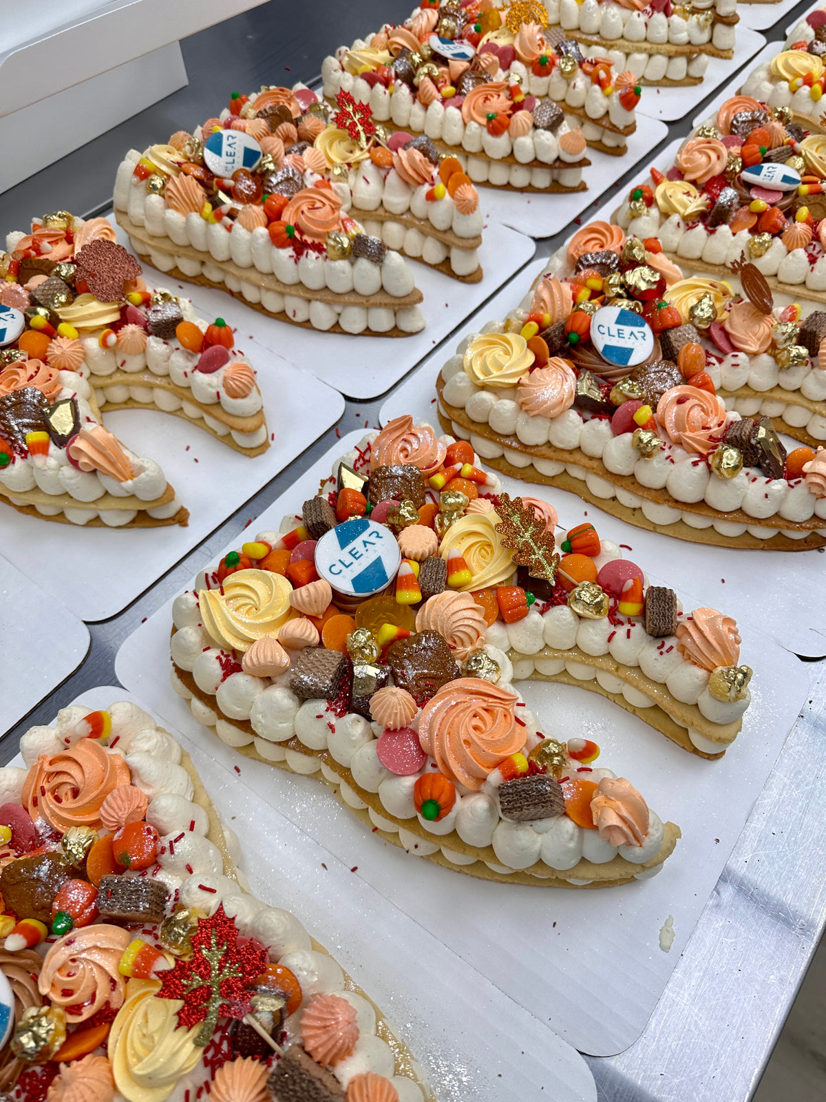 Custom letter Dream Tarts decorated with a client's company logo for a corporate celebration